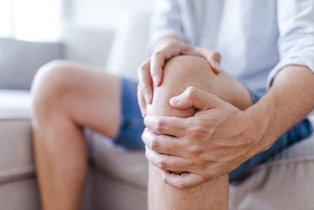 a mature man massaging his painful knee